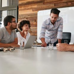 A group of people sitting around a table.